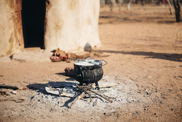 Namibia, Damaraland, iron pot boiling on a small fire in front a hut in a Himba village - GEM000484