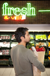 Man with paper bag of vegetables in a supermarket - RMAF000220