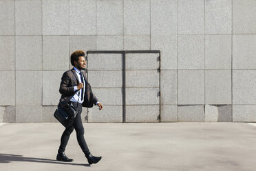 Young businessman walking outdoors - EBSF001082