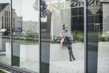 Young woman in atrium of a building - UUF006070