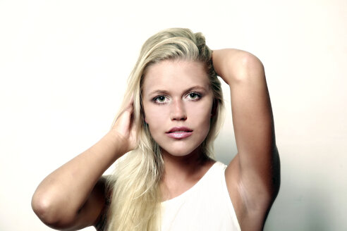 Portrait of blond young woman with hands in her hair - VEF000059