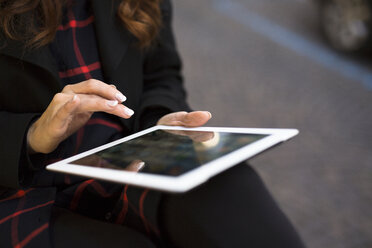 Close-up of woman using digital tablet outdoors - GIOF000537