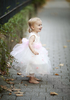 Happy blond little girl wearing tulle dress - NIF000058