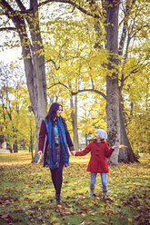 Mother and daughter walking in autumnal park - VTF000482