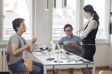 Three creative business people having a meeting in a modern office - JUBF000059