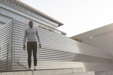 Determined athlete standing outdoors - MADF000618