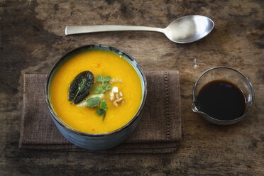 Bowl of vegan creamed pumpkin soup with walnuts and soy sauce - EVGF002527
