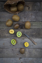 Green and golden kiwis on wood - LVF004174