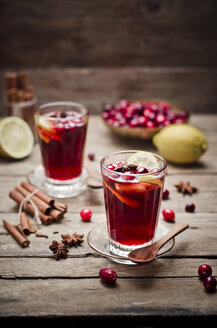 Glass of cranberry juice with fresh cranberries, lemon slices and spices - CZF000231