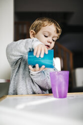 Portrait of little boy playing with cups and water - JRFF000209
