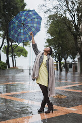 Italien, Grado, Frau mit Regenschirm an einem regnerischen Tag im Herbst - MAUF000062