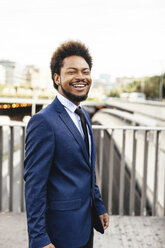 Portrait of smiling businessman wearing blue suit - EBSF001149