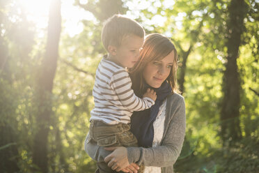 Mother with little son on her arms at backlight - PAF001482