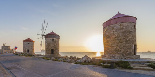 Greece, Rhodes, mole of Mandraki harbour with windmills at sunset - WDF003402