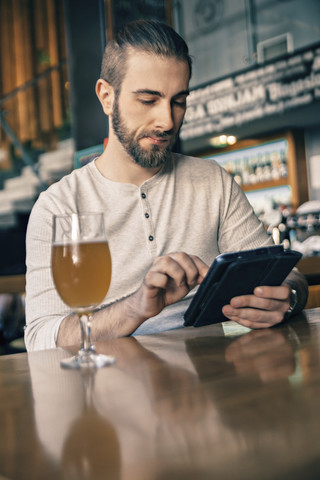 Man using digital tablet in a bar stock photo