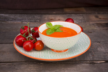 Bowl of tomato cream soup garnished with basil leaves - LVF004214
