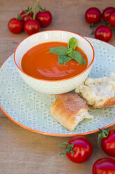 Bowl of tomato cream soup garnished with basil leaves - LVF004221