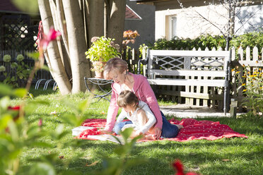 Grandmother with granddaughter in garden - FKF001638