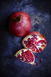 Sliced and whole pomegranate on dark ground - KSWF001684