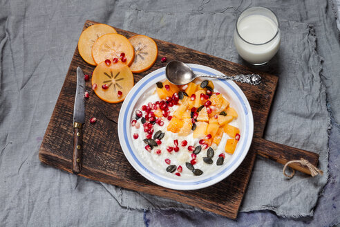 Dish of natural yoghurt, kaki, pomegranate seed, almond and pumpkin seed - SBDF002503