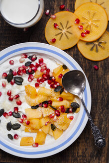Dish of natural yoghurt, kaki, pomegranate seed, almond and pumpkin seed - SBDF002504