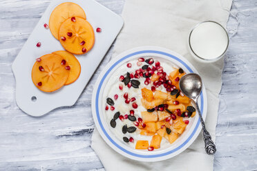 Dish of natural yoghurt, kaki, pomegranate seed, almond and pumpkin seed - SBDF002510