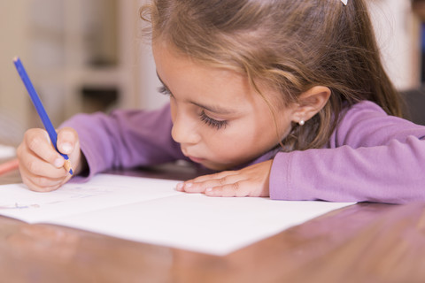 Little girl drawing stock photo