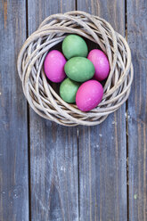 Green and pink Easter eggs in nest - SBDF002541