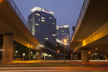 Germany, North Rhine-Westphalia, Essen, headquarters Evonik Industries, elevated road in the evening - WIF003002