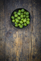 Bowl of green olives on dark wood - LVF004275