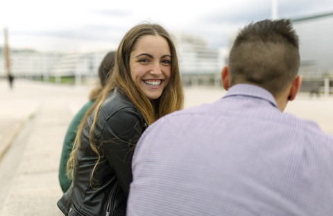 Portrait of happy teenage girl with friends outdoors stock photo