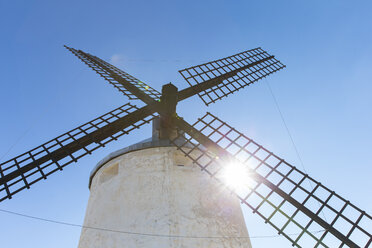 Spanien, Consuegra, alte Windmühle vor blauem Himmel bei Gegenlicht - ERLF000087