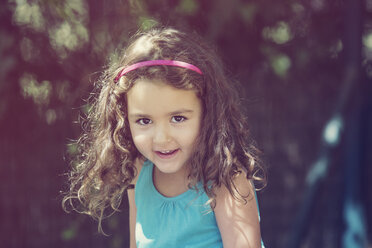 Portrait of smiling little girl with curly brown hair - ERLF000088