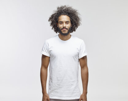 Portrait of bearded young man with curly brown hair wearing white t-shirt - RHF001092