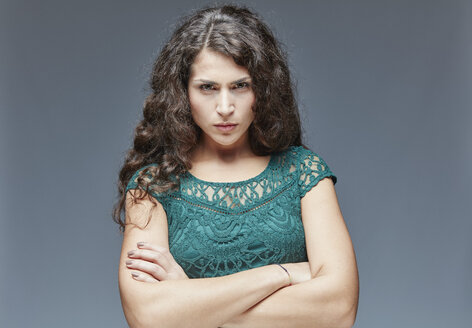 Portrait of angry young woman with crossed arms - RHF001101