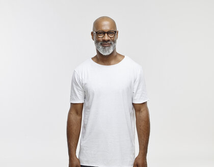 Portrait of smiling bald man with beard wearing spectacles and white t-shirt - RHF001132