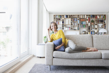 Relaxed woman at home on couch - RBF003633