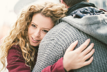 Portrait of smiling young woman hugging her boyfriend - OIPF000014