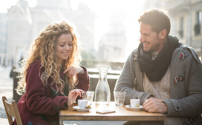 Italy, Milan, couple sitting at sidewalk cafe having fun - OIPF000024