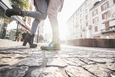 Italy, Milan, couple in love standing on cobblestone pavement - OIP000031