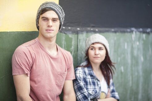 Young man and woman wearing beanies looking around - ZEF007597