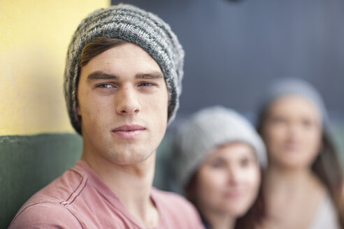 Young man wearing beanie looking around - ZEF007598