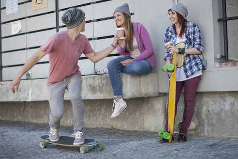Young man with friends riding skateboard - ZEF007604