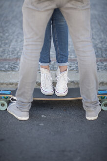 Young couple with skateboard on the street - ZEF007610