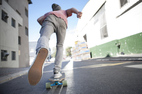Rear view of a skateboarder on the street - ZEF007613