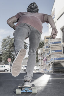 Rear view of a skateboarder on the street - ZEF007614