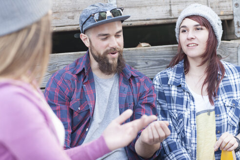 Three stylish friends socializing outdoors - ZEF007626