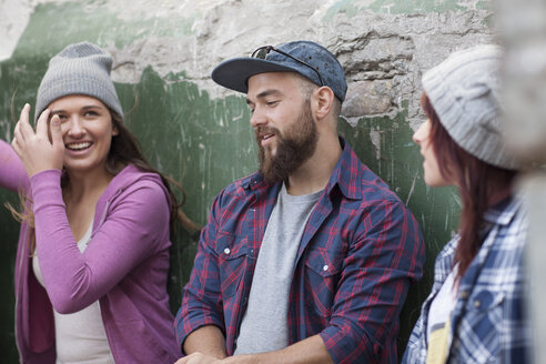 Three stylish friends socializing outdoors - ZEF007628