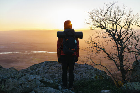 Spain, Catalunya, Girona, female hiker in the nature looking at view at sunrise - EBSF001168