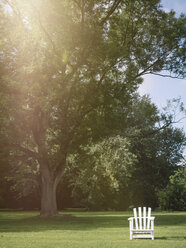 Germany, Hamburg, empty white lawn chair in a park - KRPF001688